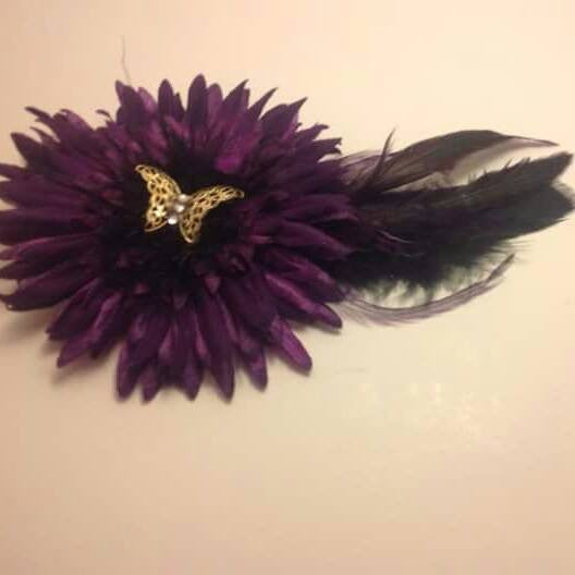 Beautiful flower and feather clip.  wonderful in hair.  a gold butterfly adds the perfect touch